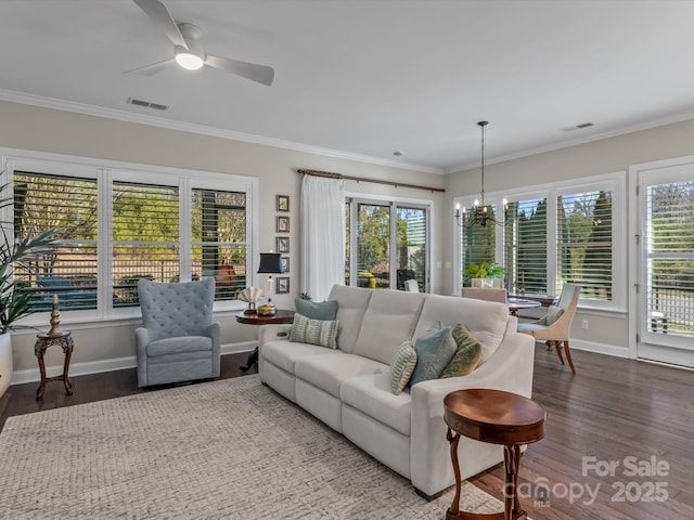 living room featuring crown molding, dark hardwood / wood-style flooring, and ceiling fan with notable chandelier