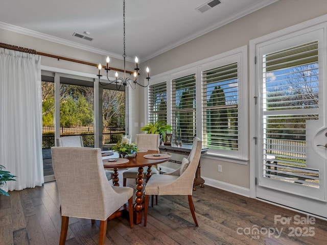 dining area with plenty of natural light, dark hardwood / wood-style floors, crown molding, and a chandelier