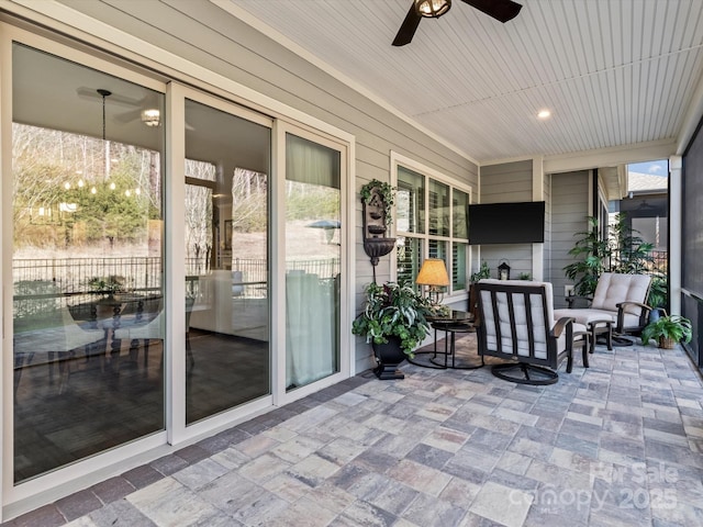 sunroom / solarium with ceiling fan and wood ceiling