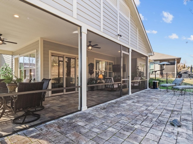 view of patio / terrace with a sunroom and ceiling fan