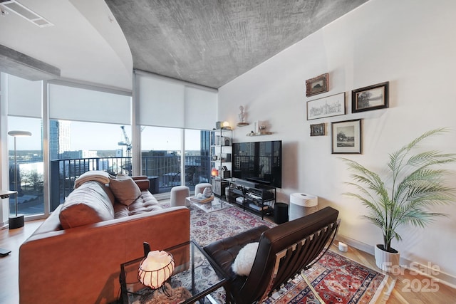 living room featuring floor to ceiling windows and hardwood / wood-style flooring