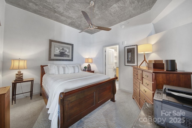 carpeted bedroom featuring ceiling fan and ensuite bath