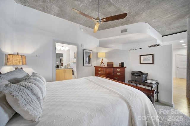 carpeted bedroom featuring ensuite bathroom and ceiling fan