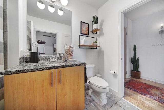 bathroom featuring ceiling fan, tile patterned flooring, vanity, and toilet