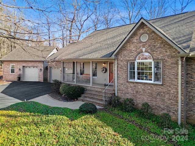 ranch-style house with covered porch and a garage