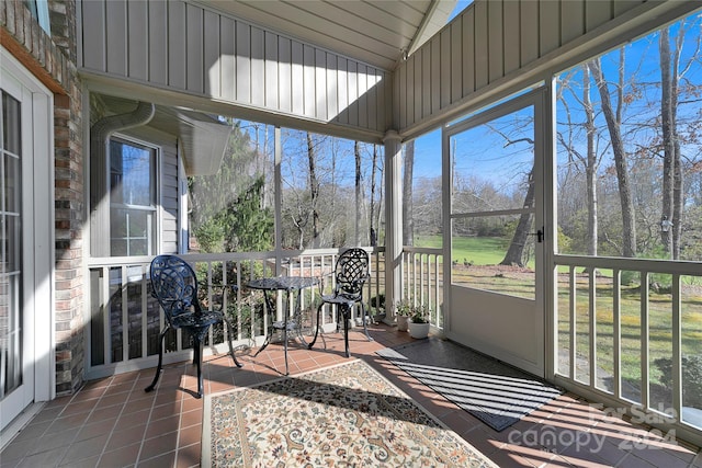 sunroom / solarium featuring lofted ceiling