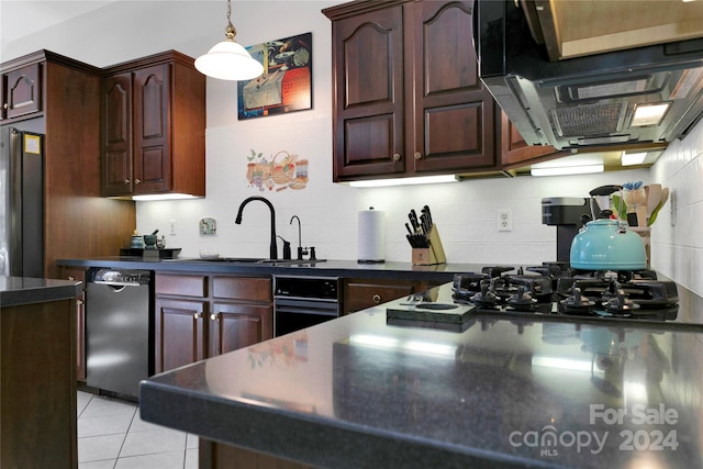 kitchen featuring light tile patterned flooring, appliances with stainless steel finishes, decorative backsplash, and sink