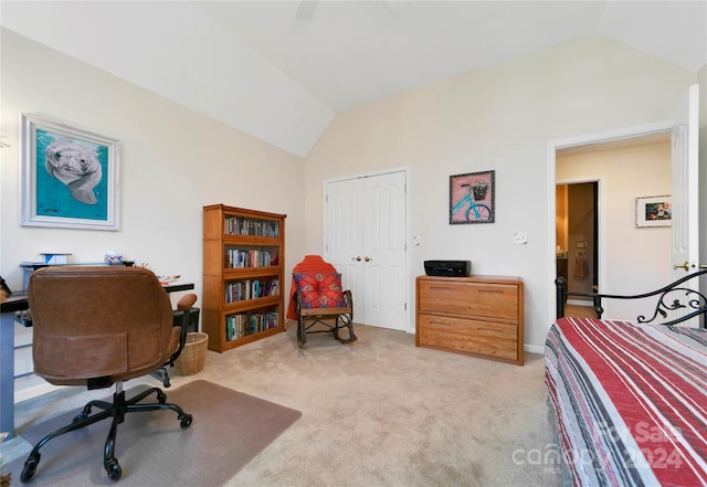 carpeted bedroom with ceiling fan, a closet, and vaulted ceiling