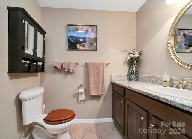 bathroom featuring tile patterned floors, vanity, and toilet