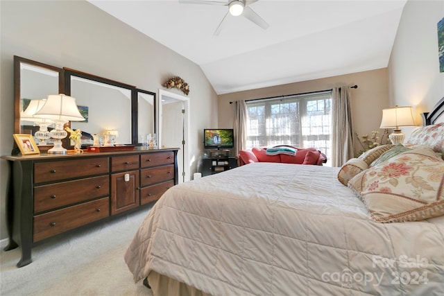 carpeted bedroom with vaulted ceiling and ceiling fan