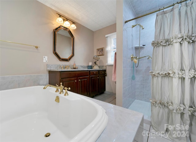 bathroom featuring shower with separate bathtub, vanity, and tile patterned floors