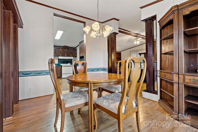 dining room featuring ceiling fan with notable chandelier, ornamental molding, and light hardwood / wood-style flooring