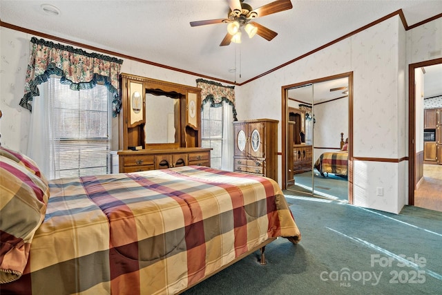 carpeted bedroom featuring ceiling fan, a textured ceiling, and ornamental molding