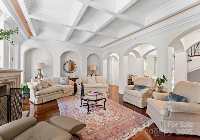 living room with ornamental molding, dark hardwood / wood-style flooring, beam ceiling, and coffered ceiling