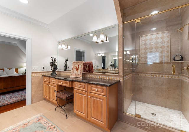 bathroom with a notable chandelier, ornamental molding, tile patterned floors, vanity, and a shower with door