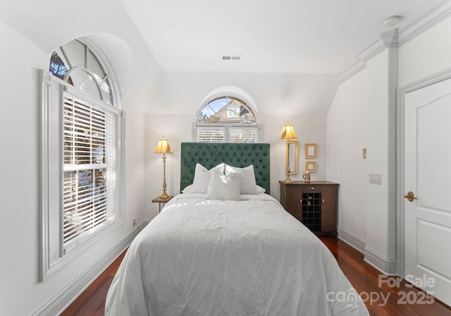 bedroom featuring dark wood-type flooring and vaulted ceiling