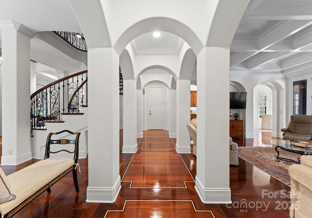 hall featuring crown molding, coffered ceiling, dark wood-type flooring, and beamed ceiling