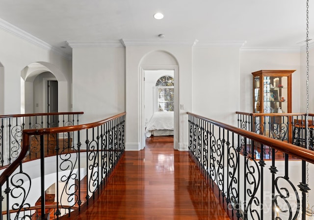 hall featuring ornamental molding and dark wood-type flooring