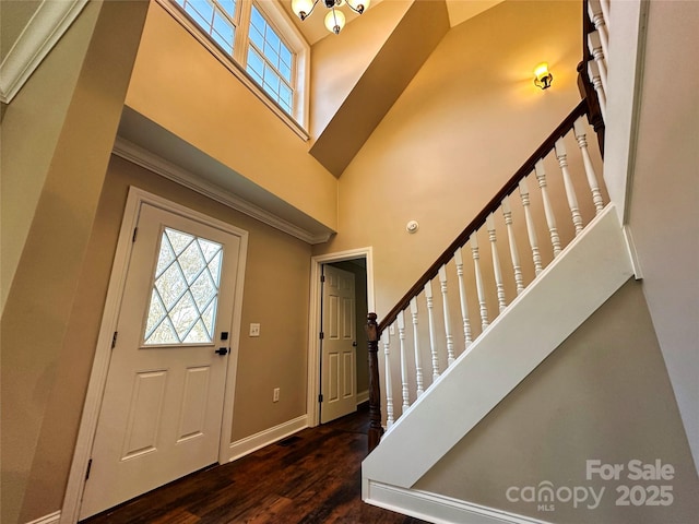 entrance foyer with dark wood-type flooring and a high ceiling