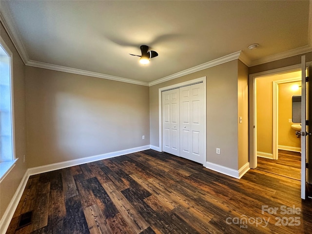 unfurnished bedroom featuring dark hardwood / wood-style flooring, a closet, and ornamental molding