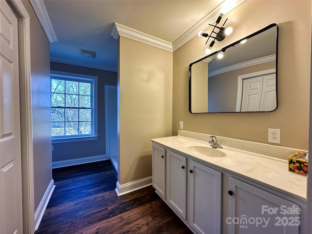 bathroom featuring wood-type flooring, vanity, and crown molding