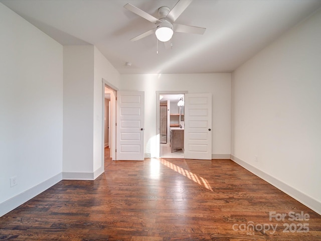 spare room with ceiling fan and dark wood-type flooring