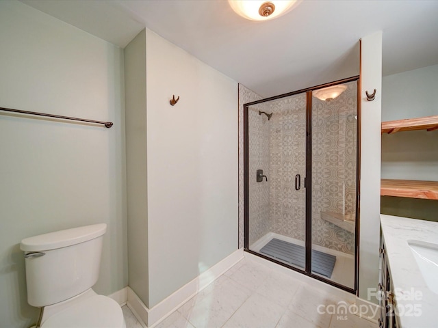 bathroom featuring tile patterned flooring, vanity, toilet, and a shower with door