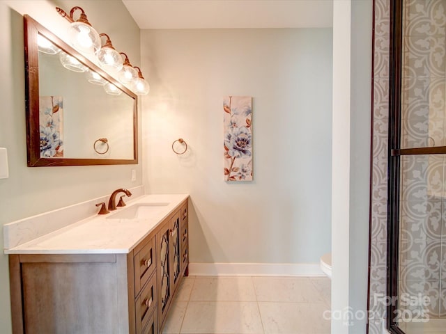 bathroom featuring tile patterned flooring, vanity, and toilet