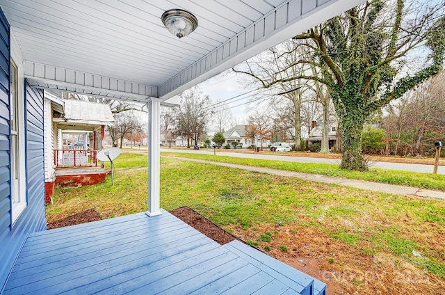 exterior space featuring a lawn and a porch