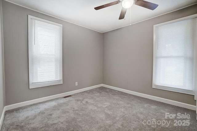 empty room with ceiling fan and light colored carpet