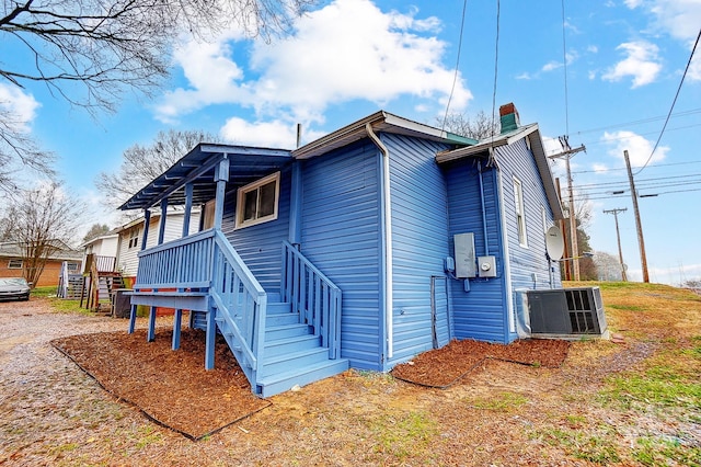 view of side of home featuring cooling unit