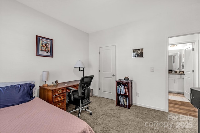 bedroom featuring light carpet and ensuite bath