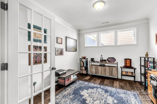 living area with dark hardwood / wood-style flooring and crown molding