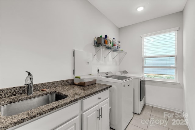 laundry area with cabinets, sink, light tile patterned floors, and washer and dryer