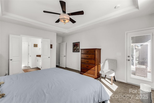 bedroom with a tray ceiling, ceiling fan, and carpet