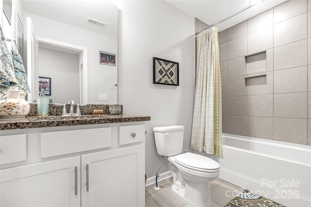 full bathroom featuring tile patterned flooring, vanity, toilet, and shower / bath combo with shower curtain