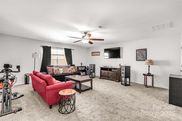 carpeted living room with ceiling fan