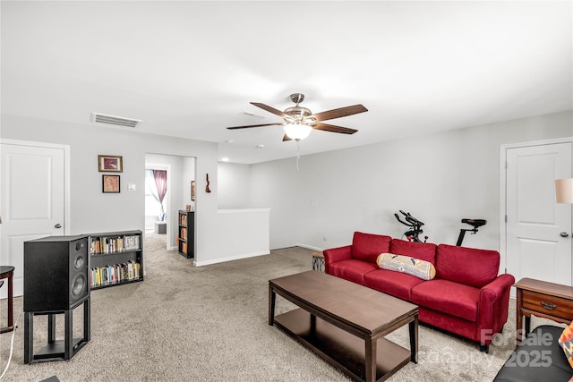 carpeted living room with ceiling fan