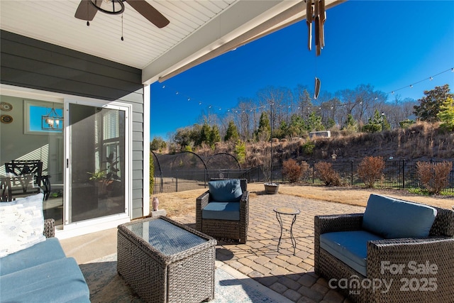 view of patio / terrace featuring ceiling fan, an outdoor hangout area, and a trampoline