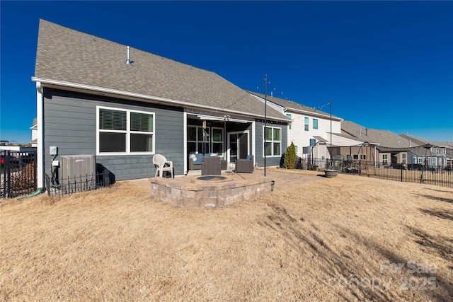 back of house featuring central AC unit, a patio area, and an outdoor fire pit