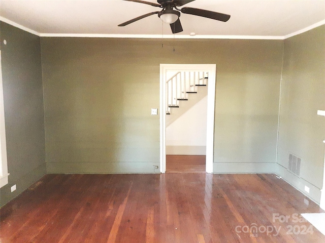 spare room featuring ceiling fan, dark hardwood / wood-style flooring, and ornamental molding