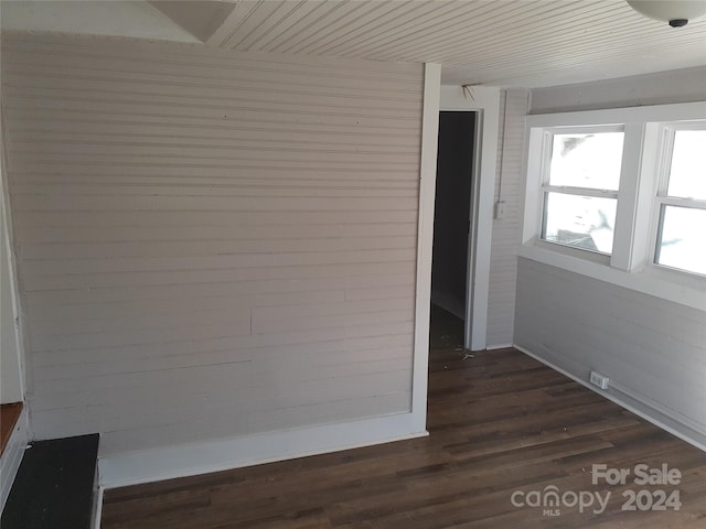 corridor with dark hardwood / wood-style flooring