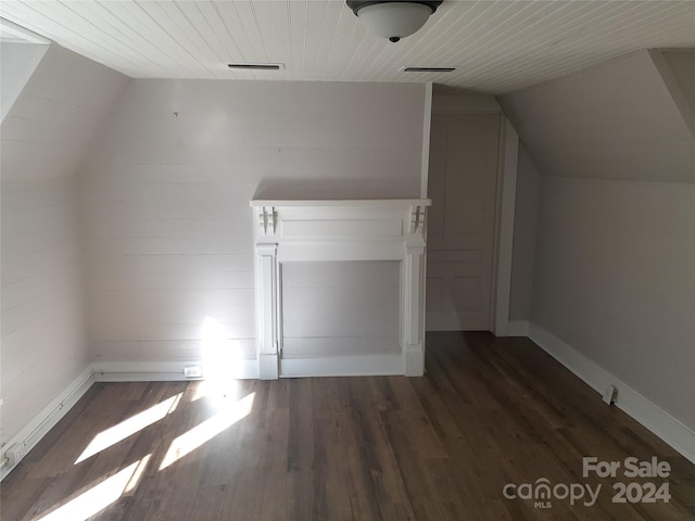 additional living space featuring dark hardwood / wood-style floors, vaulted ceiling, and wooden ceiling