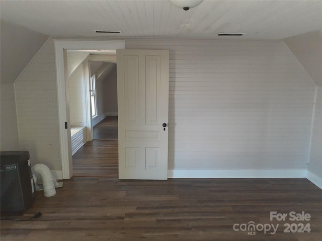 bonus room with dark hardwood / wood-style flooring and lofted ceiling