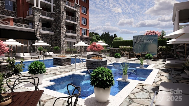 view of pool featuring an outdoor fire pit, a patio area, and pool water feature