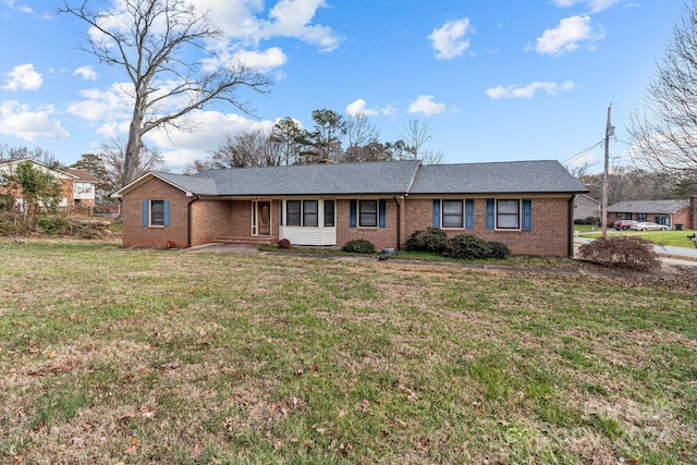 ranch-style home with a front lawn