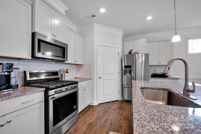 kitchen featuring light stone counters, sink, white cabinets, and stainless steel appliances