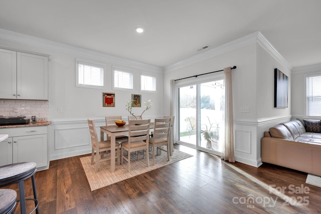 dining room featuring dark hardwood / wood-style floors and ornamental molding