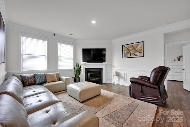 living room featuring wood-type flooring and ornamental molding