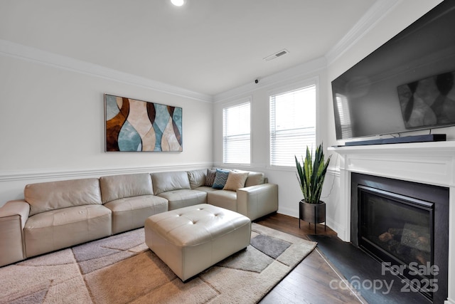 living room with hardwood / wood-style flooring and ornamental molding